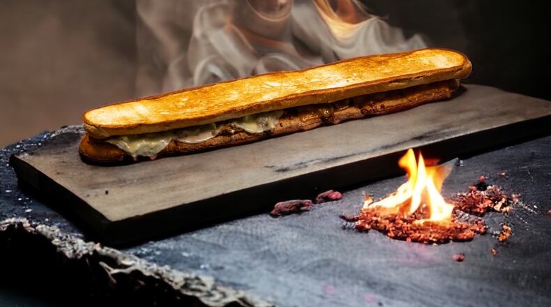 The two-foot-long “dueling” grilled cheese ($25) will be served during the 2023 SEC Championship Game at the 100 level Molly B's concession stand.