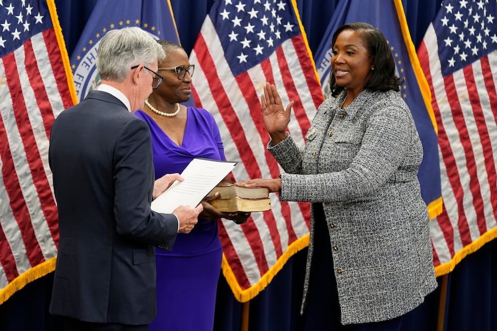 Lisa Cook (right) is pictured taking the oath of office to become a member of the Federal Reserve Board three years ago in Washington.