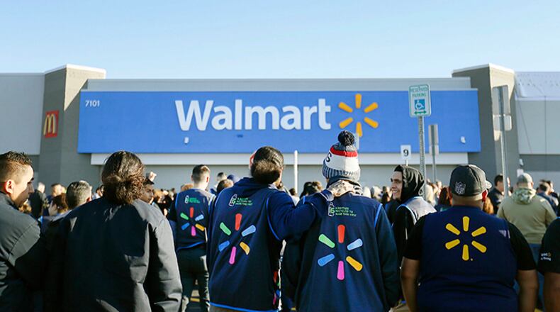 Walmart employees gather outside the Walmart store for a reopening event, Thursday in El Paso, Texas.