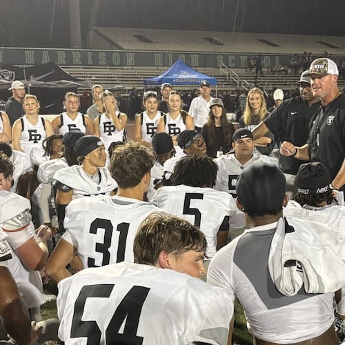 East Paulding coach Van Spence speaks to his players after the Raiders’ 27-23 victory over Harrison on Friday, Aug. 28, 2026, at Cobleigh Stadium. (Chip Saye/AJC)