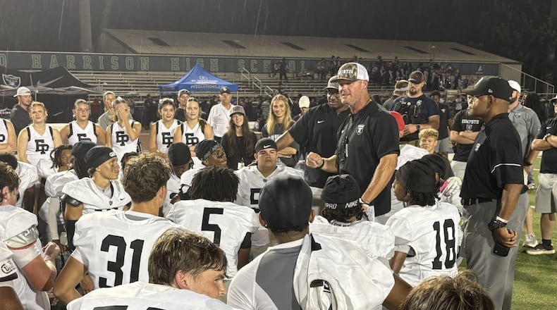 East Paulding coach Van Spence speaks to his players after the Raiders’ 27-23 victory over Harrison on Friday, Aug. 28, 2026, at Cobleigh Stadium. (Chip Saye/AJC)