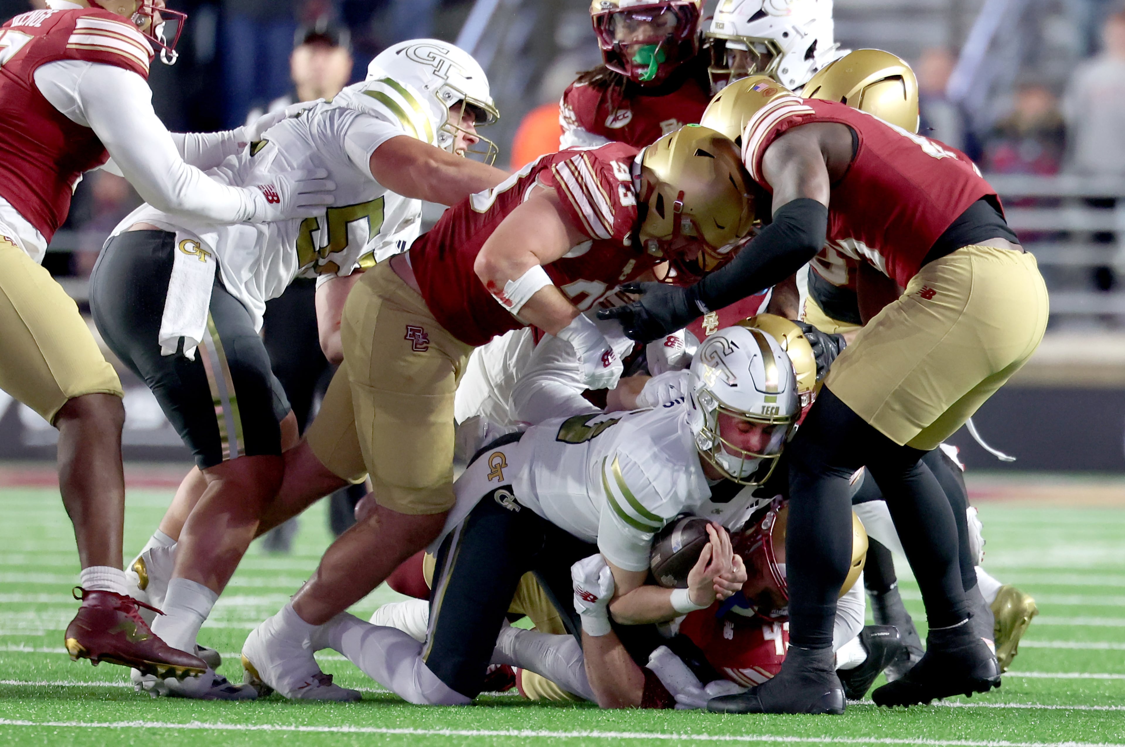 Georgia Tech quarterback Haynes King, second from bottom, is tackled during the first half of an NCAA college football game against Boston College, Saturday, Nov. 15, 2025, in Boston. (AP Photo/Mark Stockwell)