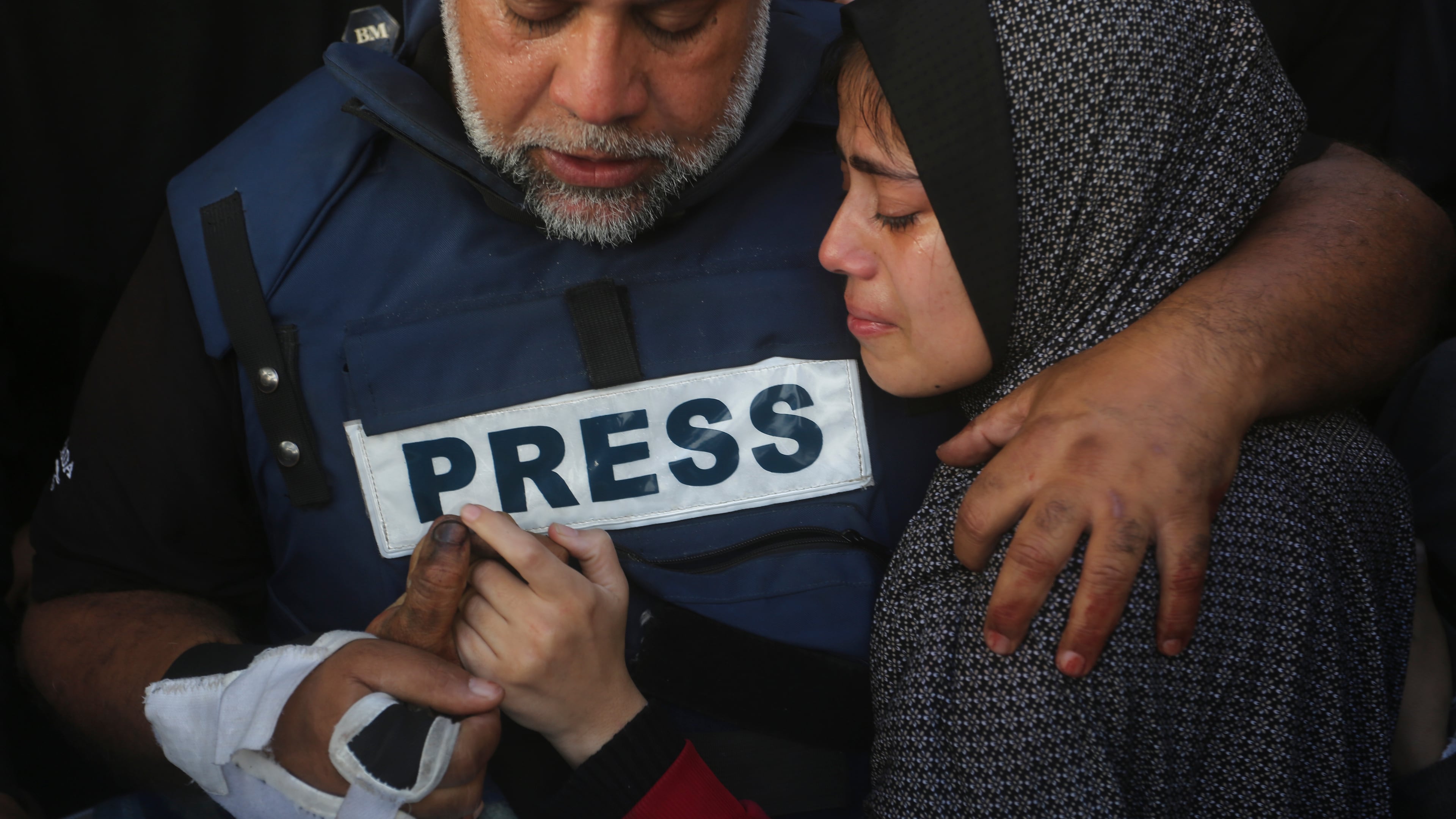 FILE - Al Jazeera journalist Wael Dahdouh holds the hand of his son, Hamza, who also worked for Al Jazeera and was killed in an Israeli airstrike, in Rafah, Gaza Strip, Jan. 7, 2024. (AP Photo/Hatem Ali, File)