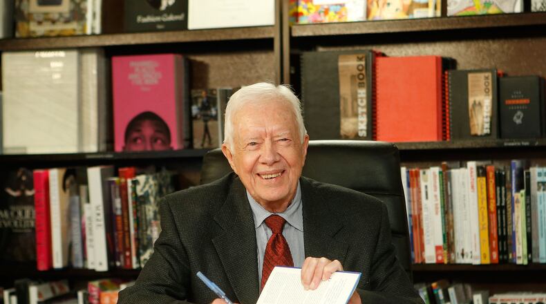 Former US President Jimmy Carter poses for a photo as he promotes his new book "A Call To Action Women, Religion, Violence, And Power" at Barnes & Noble, 5th Avenue on March 25, 2014 in New York City. (Photo by Jemal Countess/Getty Images)