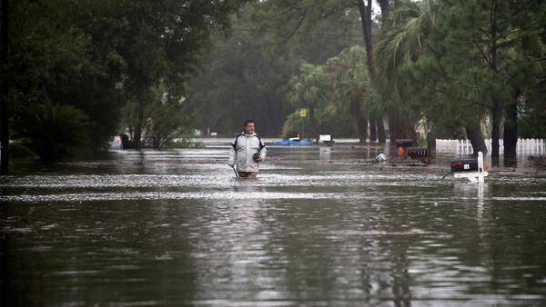 Joey Spalding walks back to his truck down the street where he lives, in 2017 on Tybee Island, Ga. Georgia was hit by Hurricane Matthew in 2016, Hurricane Irma in 2017 and Hurrcane Dorian in 2019.(AP Photo/Stephen B. Morton)