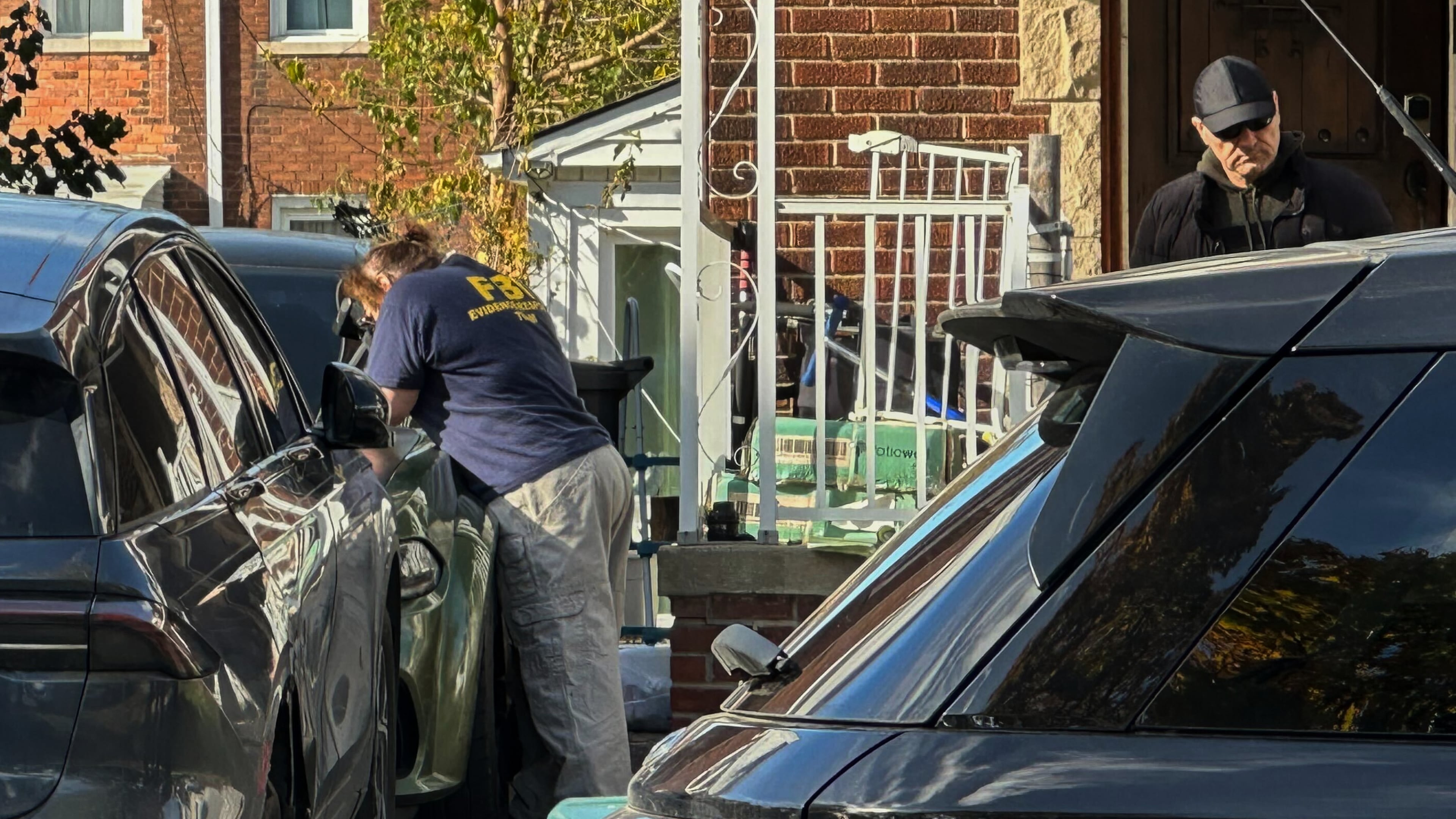 FBI agents gather outside a home in a Dearborn, Mich., neighborhood on Friday, Oct. 31, 2025. (AP Photo/Mike Householder)