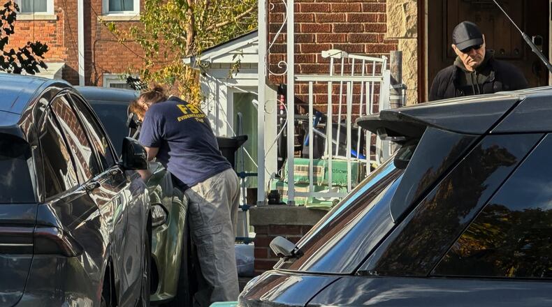 FBI agents gather outside a home in a Dearborn, Mich., neighborhood on Friday, Oct. 31, 2025. (AP Photo/Mike Householder)