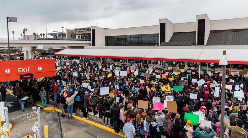 Protesters gather in front of the south domestic terminal at Hartsfield-Jackson International Airport on Sunday in protest of President Donald J. Trump's executive order on immigration. Cory Hancock/AJC