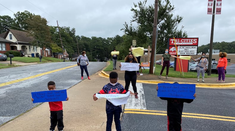 Fulton County Schools teachers and children protest the district's plan of returning to face-to-face instruction with a walkout during lunch on Thursday, Sept. 17, 2020.