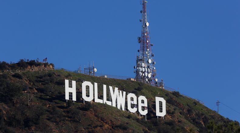 The Hollywood sign is seen vandalized Sunday, Jan. 1, 2017. Los Angeles residents awoke New Year's Day to find a prankster had altered the famed Hollywood sign to read "HOLLYWeeD." Police have notified the city's Department of General Services, whose officers patrol Griffith Park and the area of the rugged Hollywood Hills near the sign. California voters in November approved Proposition 64, which legalized the recreational use of marijuana, beginning in 2018. (AP Photo/Damian Dovarganes)