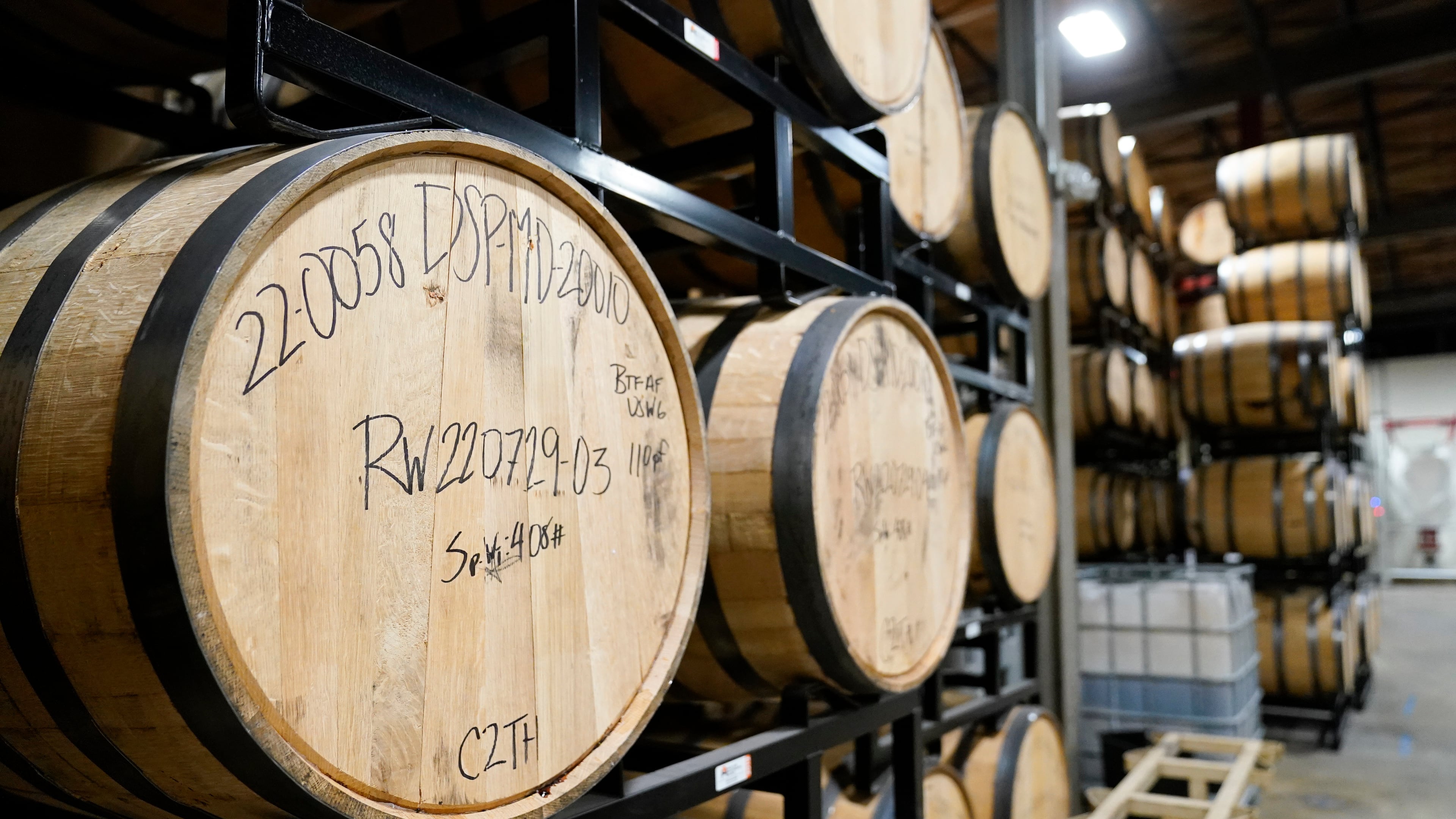 FILE - Barrels of spirits are seen at the Baltimore Spirits Company distillery, Feb. 8, 2023, in Baltimore. (AP Photo/Julio Cortez, file)