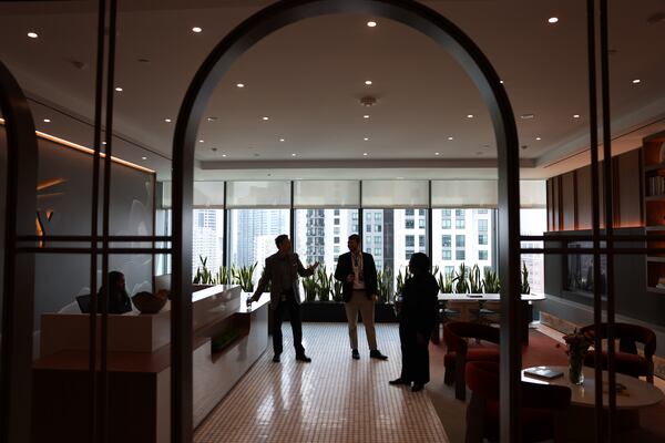 AJC reporter Zach Hansen (center) tours EY’s new offices at Ten Twenty Spring in Atlanta on Aug. 26, 2026. (Arvin Temkar/AJC)