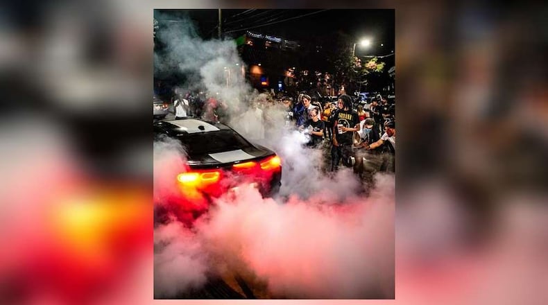 A large crowd gathers to watch cars do burnouts in Atlanta. Authorities are looking for ways to crack down on the recent spike in illegal street racing across the city. (Photo courtesy of Ben Hendren)