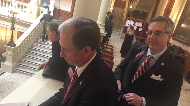 State Rep. Eddie Lumsden, R-Armuchee, left, signs on to co-sponsor a bill Tuesday that would permit guns on college campuses as state Rep. Brad Raffensperger, R-Johns Creek, watches. State Rep. Mandi Ballinger, R-Canton, filed the bill Tuesday. AARON GOULD SHEININ / ASHEININ@AJC.COM