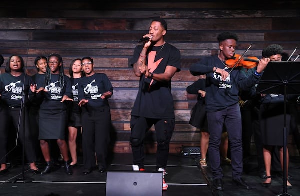 Grammy-winning Christian hip-hop artist Lecrae performs "Blessings" with the Atlanta Music Project at the grand opening of its training facility in southwest Atlanta in May 2019. Courtesy of Atlanta Music Project