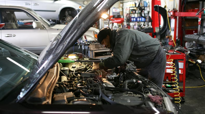 FILE PHOTO: A mechanic works on a car .
