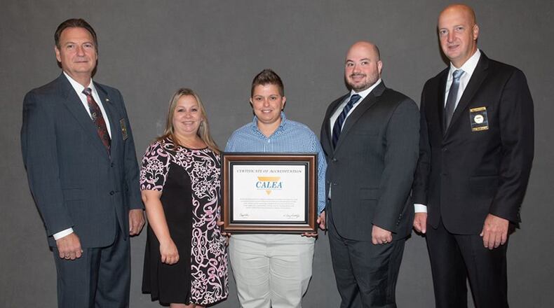 The Commission on Accreditation for Law Enforcement Agencies (CALEA) renews the Cherokee E 9-1-1 Center’s accreditation. Pictured (from left) are Craig Webre, president/chair of CALEA; Cherokee 911 Operations Commander Linda Miller, Administrative Commander Alice Fennell and Accreditation Manager Aaron Schwab; and Craig Hartley, CALEA executive director.