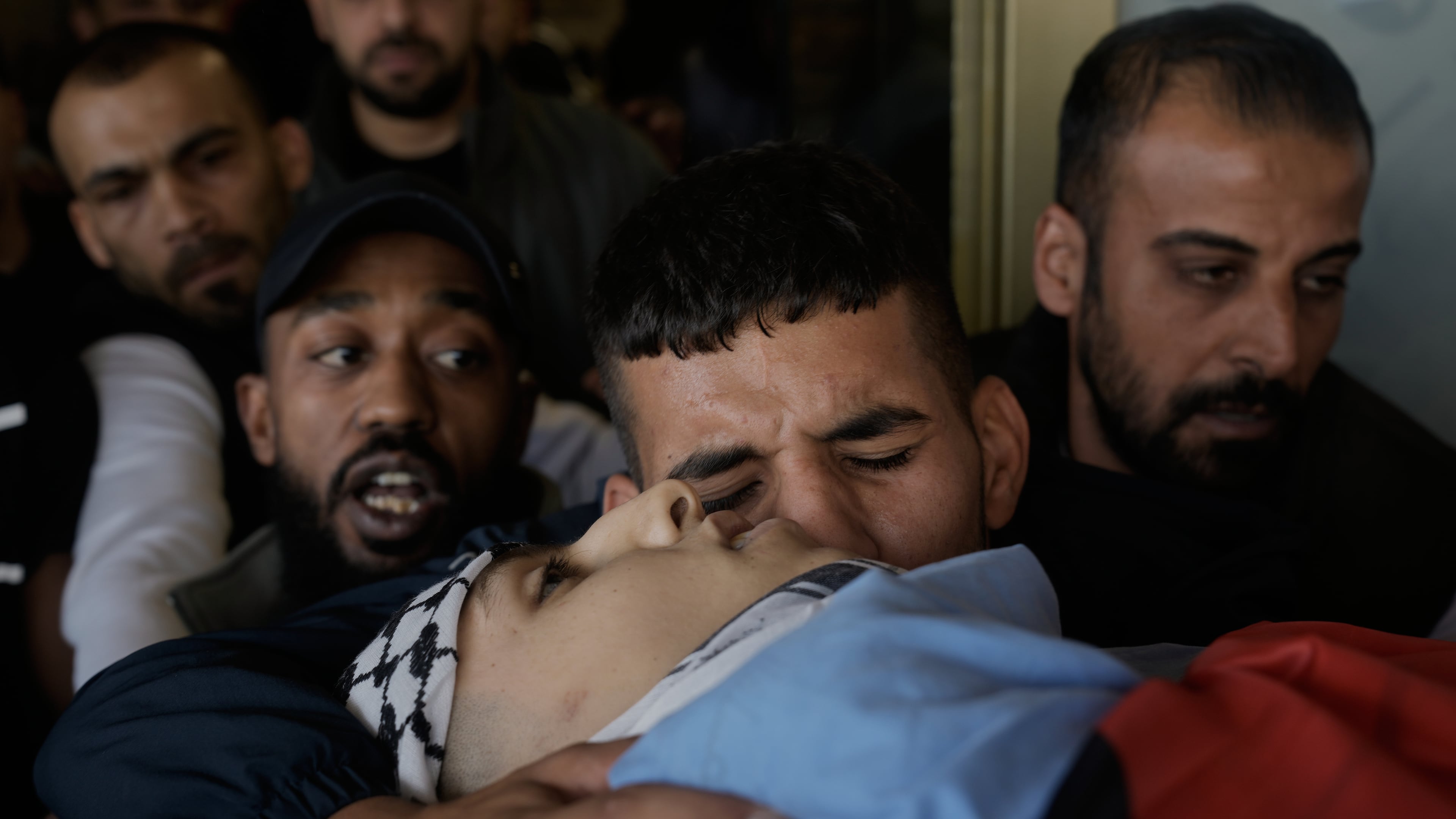 Palestinians mourn during the funeral of Hassan Ahmed Jamil Moussa,19, who, according to health authorities, was killed during an Israeli raid last night in Askar camp near the West Bank city of Nablus, Sunday, Nov. 16, 2025. (AP Photo/Majdi Mohammed)
