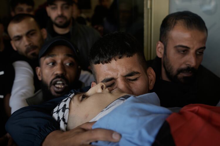 Palestinians mourn during the funeral of Hassan Ahmed Jamil Moussa,19, who, according to health authorities, was killed during an Israeli raid last night in Askar camp near the West Bank city of Nablus, Sunday, Nov. 16, 2025. (AP Photo/Majdi Mohammed)