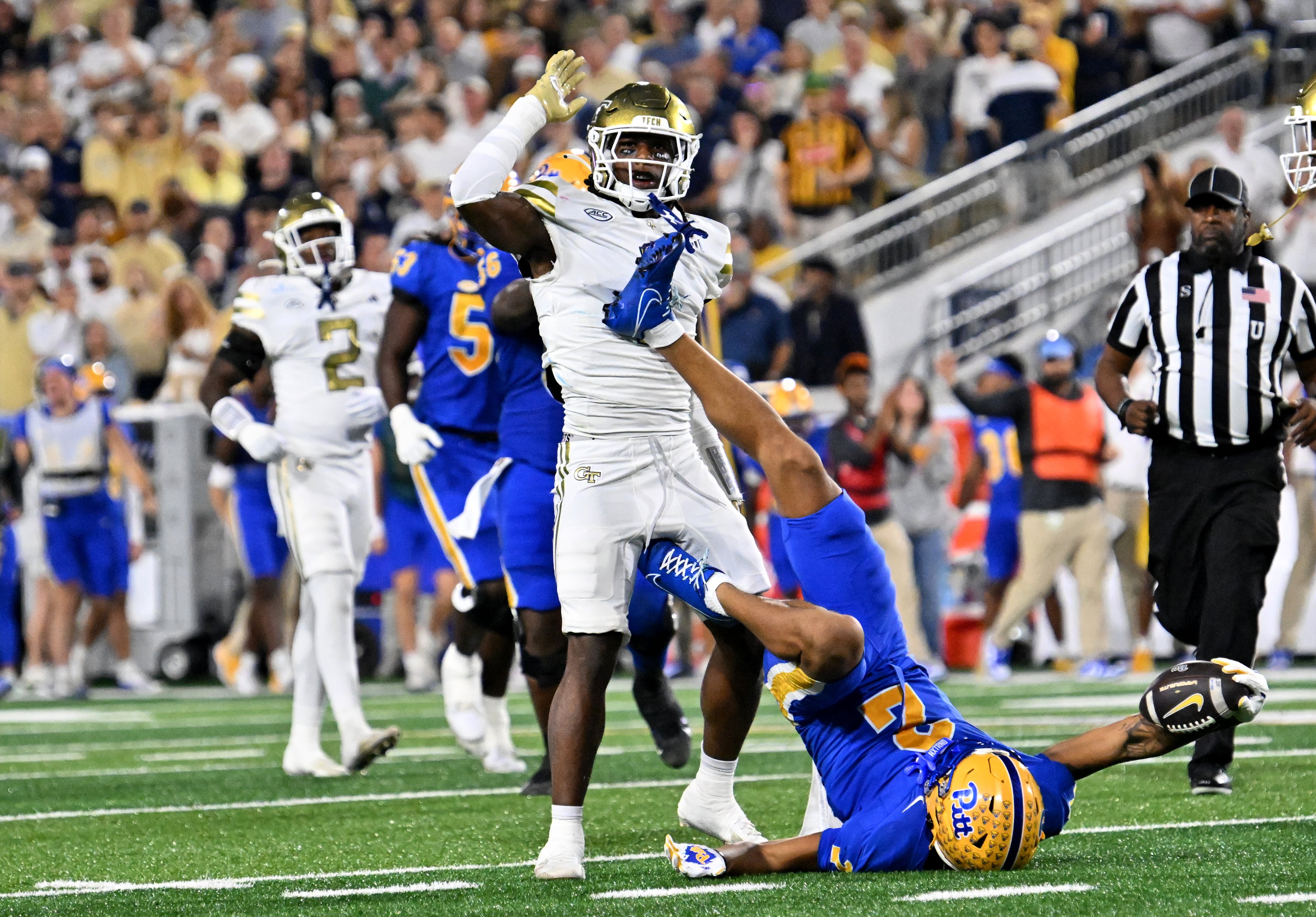 Georgia Tech linebacker Cayman Spaulding (1) reacts after tacking Pittsburgh wide receiver Kenny Johnson (2) during the first half in an NCAA college football game at Bobby Dodd Stadium, Saturday, November 22, 2025 in Atlanta. Pittsburgh won 42-28 over Georgia Tech. (Hyosub Shin / AJC)