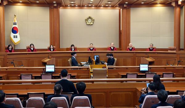 Moon Hyung-bae, fourth right, acting chief justice of South Korea's Constitutional Court, presides over the impeachment verdict for South Korean Prime Minister Han Duck-soo at the Constitutional Court in Seoul Monday, March 24, 2025. (Kim Min-Hee/Pool Photo via AP)