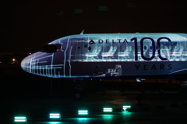 Delta Air Lines unveiled a special centennial-themed plane design with a light show during its 100-year anniversary celebration on March 15 at the Delta Flight Museum. (Jenni Girtman for the AJC)