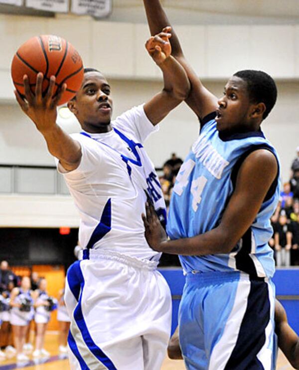Centennial's Lorenzo Brown (left) goes up against Meadowcreek High's Tyler McDaniels. (Rich Addicks/AJC)