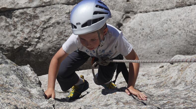 Oliver Cripe climbs a 40-foot rock face on Five Cracks at City of Rocks National Reserve near Almo, Idaho. The rock often is used as part of the Climbing Experience Program, which gives visitors a taste of the park’s most popular activity. (Chadd Cripe/The Idaho Statesman/TNS)