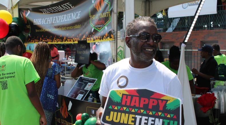 Brett Ringer, of Atlanta, welcomes people to the Photoboss 360 ATL photo booth during the 21st Annual Cobb NAACP Juneteenth Celebration in Marietta on Sunday. (Photo Courtesy of Isabelle Manders)