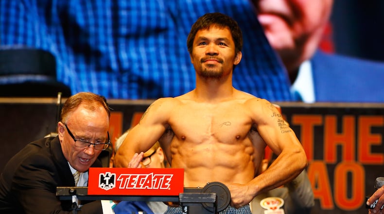 LAS VEGAS, NV - MAY 01: Manny Pacquiao poses on the scale during his official weigh-in on May 1, 2015 at MGM Grand Garden Arena in Las Vegas, Nevada. Pacquiao will face Floyd Mayweather Jr. in a welterweight unification bout on May 2, 2015 in Las Vegas. (Photo by Al Bello/Getty Images)