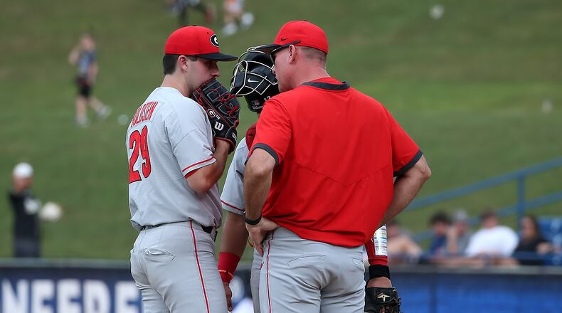 Georgia pitcher Charlie Goldstein (29) confers with pitching coach Sean Kenny and catcher Fernando Gonzalez early during the Bulldogs' game against No. 1 Arkansas in the SEC Tournament in Hoover, Ala., on Wednesday, May 26, 2021. (Photo by Michael Wade/SEC)
