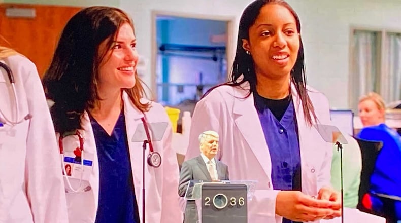 Emory University President Gregory Fenves speaks at a lectern in front of an image of some of its medical students at a program on Oct. 20, 2021 to kick off the public phase of its $4 billion fundraising campaign. (Eric Stirgus/eric.stirgus@ajc.com.)
