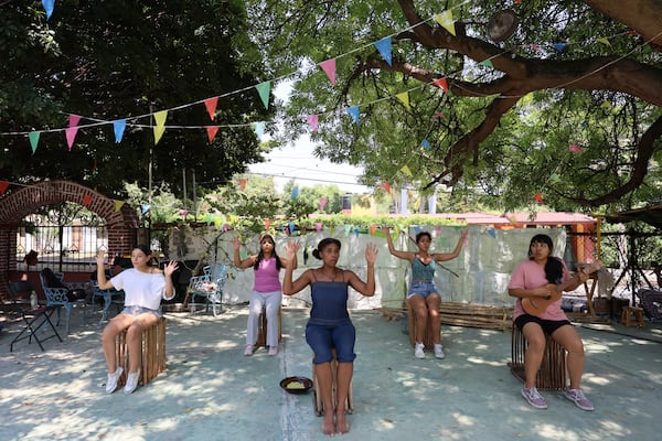 Mulato Teatro cast members from left to right, Azul Ruíz; Marlene Romero; Marisol Castillo; Caro Rodríguez and Eréndira Castorela strumming a jarana instrument, rehearse for their upcoming performance in the First International Afro-Scenic Festival, in Ticumán, Mexico, Saturday, May 17, 2025. (AP Photo/Ginnette Riquelme)