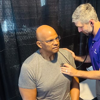 Dr. Connor O'Sullivan examines former Atlanta Falcons player and NFL retiree Philip McKinnely at NFL health screening in Atlanta on Saturday, April 18, 2026. (Courtesy of Wellstar Health System)