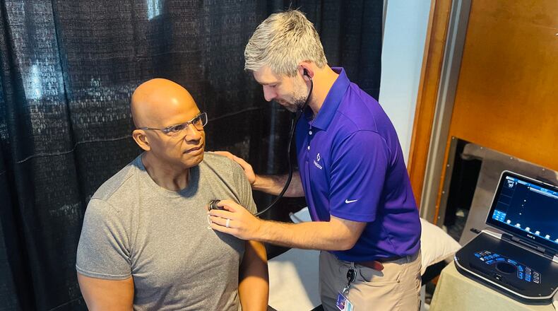 Dr. Connor O'Sullivan examines former Atlanta Falcons player and NFL retiree Philip McKinnely at NFL health screening in Atlanta on Saturday, April 18, 2026. (Courtesy of Wellstar Health System)