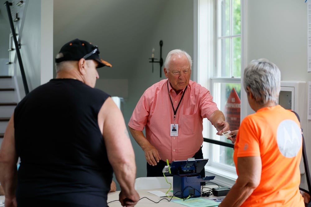 Michael Parnow assisted voters in Canton on Tuesday.