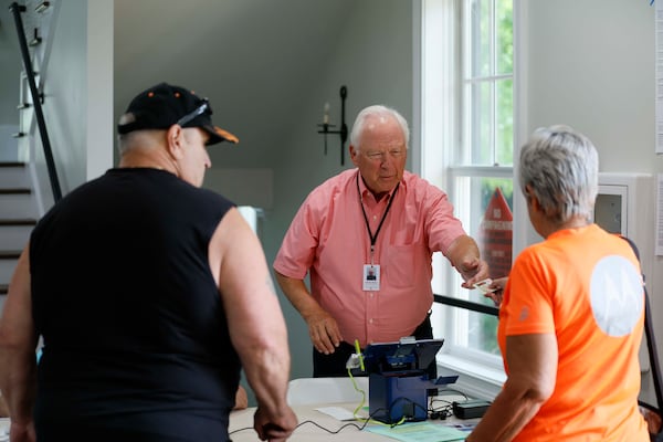 Michael Parnow assisted voters in Canton on Tuesday.