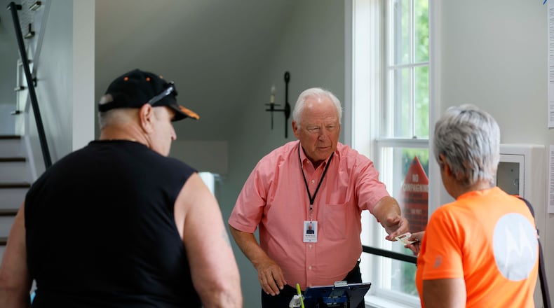 Michael Parnow, a poll manager at Canton City Hall, assists voters at the Riverr-Green subdivision in Canton during the special election for the state senate seat in Cherokee on Tuesday, August 26,2025, to complete the term of former state Sen. Brandon Beach, which runs through January 2027.
(Miguel Martinez/ AJC)