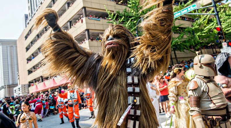 Dressed as Chewbacca, Matt Pfingsten throws his hands into the air during the annual DragonCon Parade in Atlanta on Saturday, September 5, 2015. JONATHAN PHILLIPS / SPECIAL