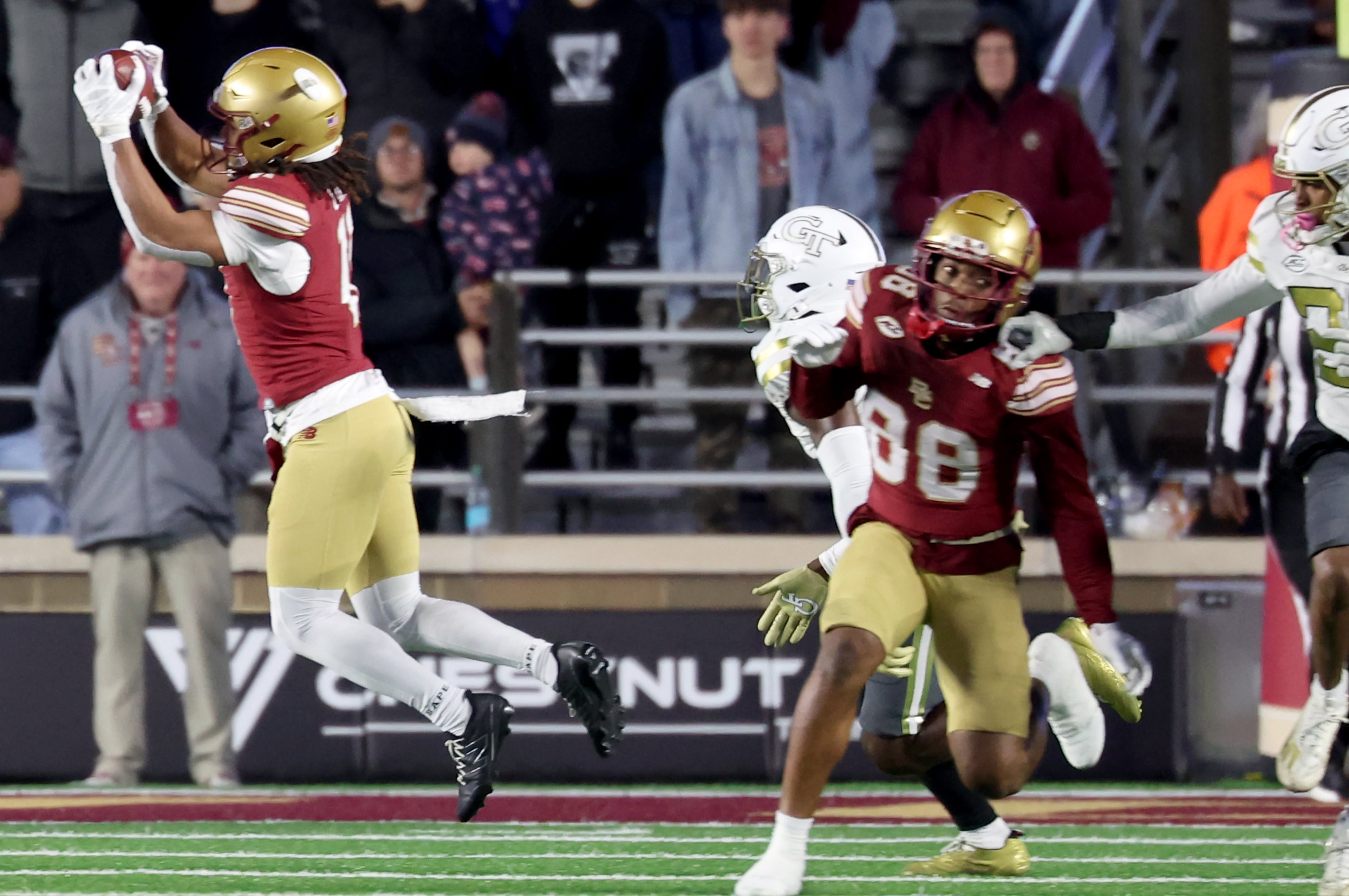 Boston College wide receiver Lewis Bond, left, catches the ball to break his school's record for receptions during the first half of an NCAA college football game against Georgia Tech, Saturday, Nov. 15, 2025, in Boston. (AP Photo/Mark Stockwell)