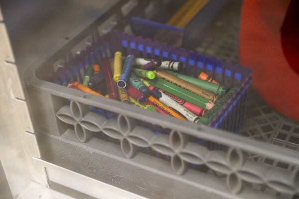 Crayons and pencils, along with other day care items, are sanitized in the ZONO Sanitizing cabinet at the Kids R Kids Learning Academy day care center in Marietta. ALYSSA POINTER / ALYSSA.POINTER@AJC.COM