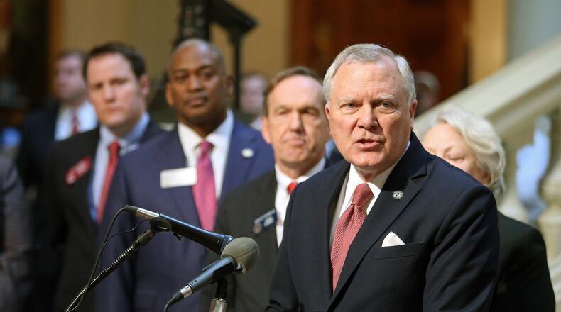 With several of the DeKalb delegation behind him, Gov. Nathan Deal announces that he'll remove all six DeKalb school board members at a new conference at the west wing of the Capitol Monday afternoon in Atlanta, Ga., February 25, 2013. JASON GETZ / JGETZ@AJC.COM