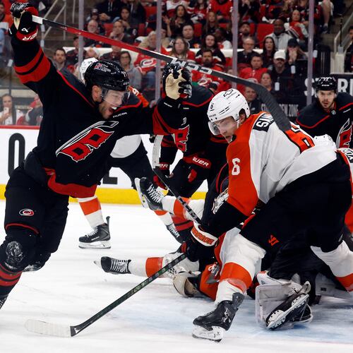 Carolina Hurricanes' Taylor Hall, left, celebrates after his winning overtime goal as Philadelphia Flyers' Travis Sanheim (6) looks on during Game 2 of an NHL hockey Stanley Cup second-round playoff series in Raleigh, N.C., Monday, May 4, 2026. (AP Photo/Karl DeBlaker)
