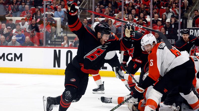 Carolina Hurricanes' Taylor Hall, left, celebrates after his winning overtime goal as Philadelphia Flyers' Travis Sanheim (6) looks on during Game 2 of an NHL hockey Stanley Cup second-round playoff series in Raleigh, N.C., Monday, May 4, 2026. (AP Photo/Karl DeBlaker)