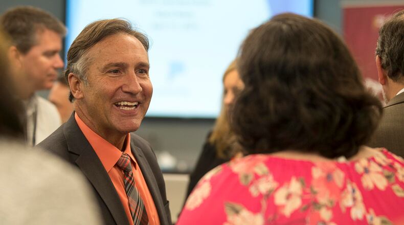 Fulton County Schools superintendent finalist Mike Looney (left) greets individuals following a news conference last week at which he was named the sole finalist for the district's top job. (ALYSSA POINTER/ALYSSA.POINTER@AJC.COM)