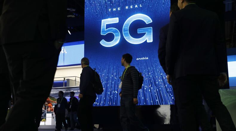 A sign advertises 5G at the Qualcomm booth at CES International in Las Vegas in 2019. 5G is a new technical standard for wireless networks that promises faster speeds; less lag, or “latency,” when connecting to the network; and the ability to connect many devices to the internet without bogging it down. (AP Photo/John Locher, File)