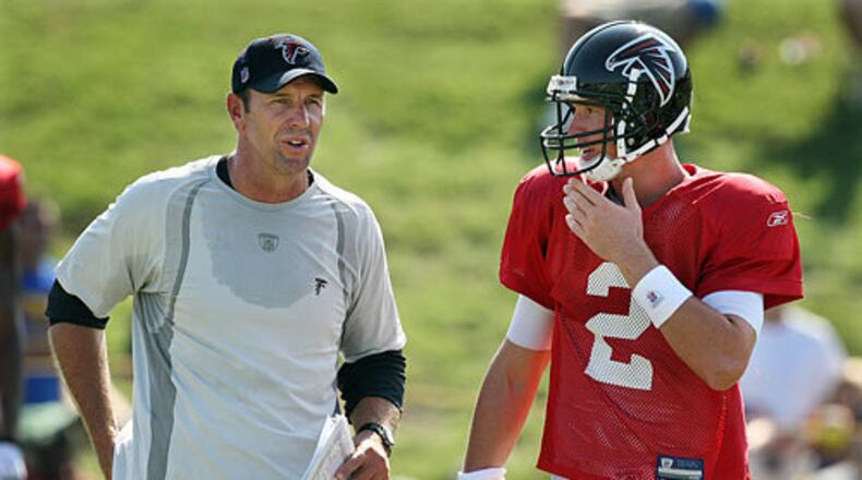Offensive coordinator Mike Mularkey confers with quarterback Matt Ryan between plays.