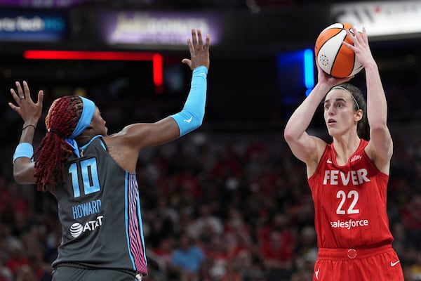 Indiana Fever's Caitlin Clark (22) shoots over Atlanta Dream's Rhyne Howard (10) during the second half of a WNBA basketball game, Friday, July 11, 2025, in Indianapolis. (AP Photo/AJ Mast)