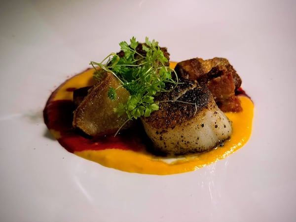 Pan-roasted scallop and pork belly is among the recommended dishes at Vice Steak Bar. (Henri Hollis/AJC)