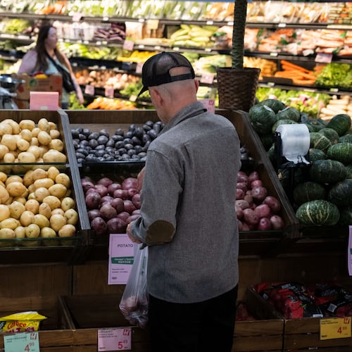 Customers shop in the produce section of a grocery store on Monday, May 11, 2026, in Portland, Ore. (AP Photo/Jenny Kane)